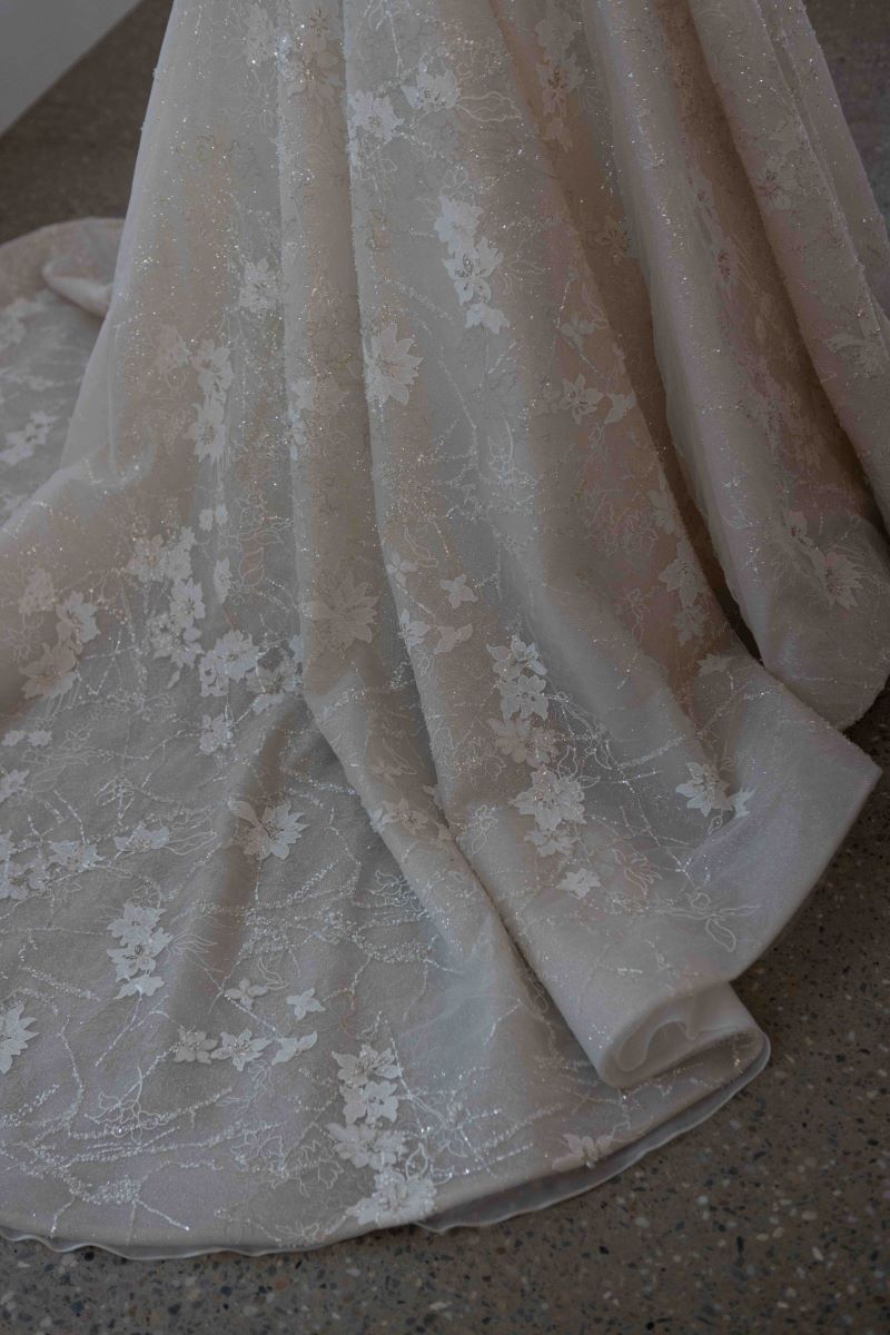 white wedding dress with flowers embroided in the dress