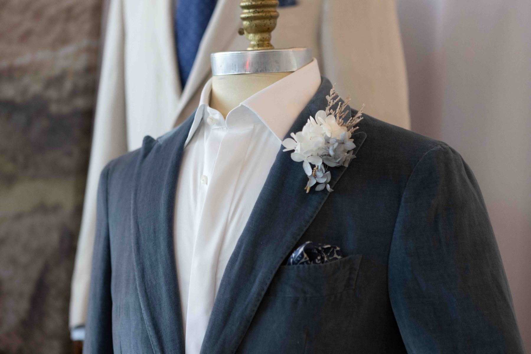 gray tuxedo with a boutineer with with flowers pinned to it
