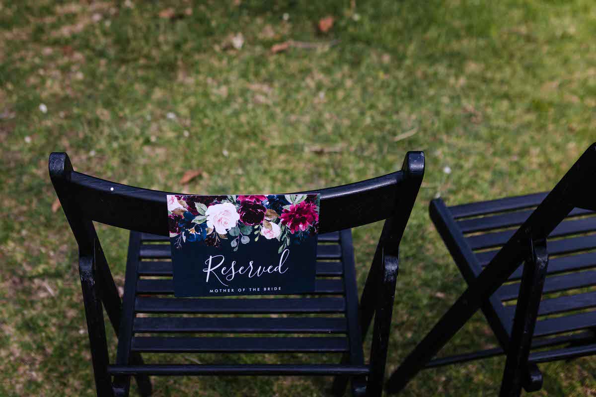 Documentary style wedding photography of a chair with a reserved sign on it