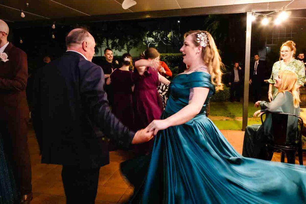 Wedding guests dancing at a reception at night