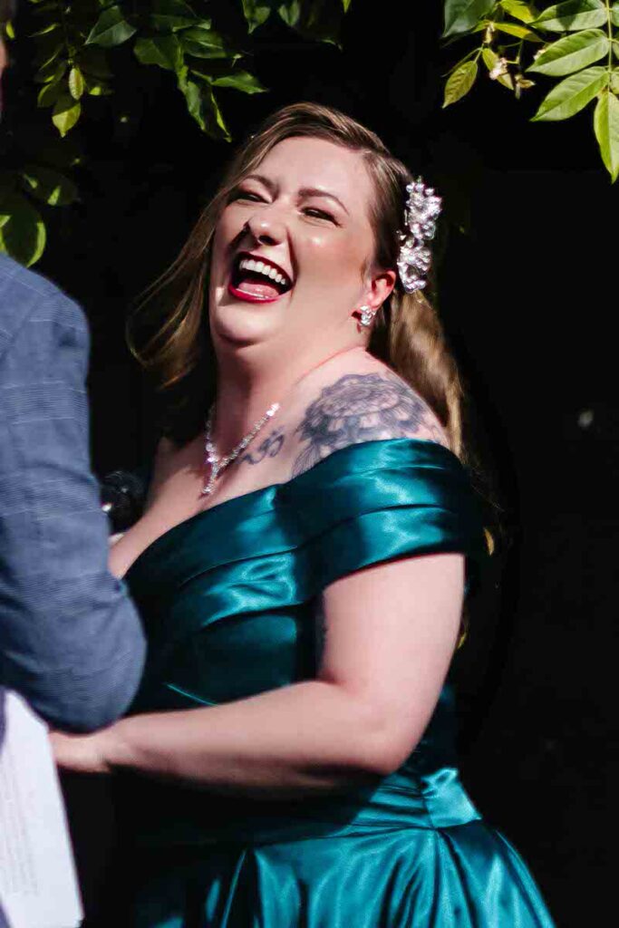 A bride laughing during a wedding ceremony