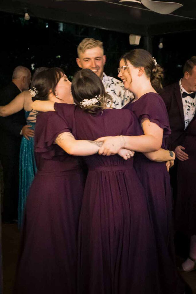 Guests hugging at a wedding reception