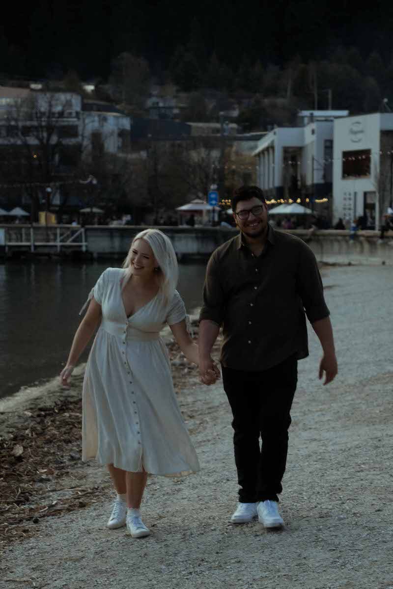 A couple holding hands and walking together showing what to wear for engagement photos in summer
