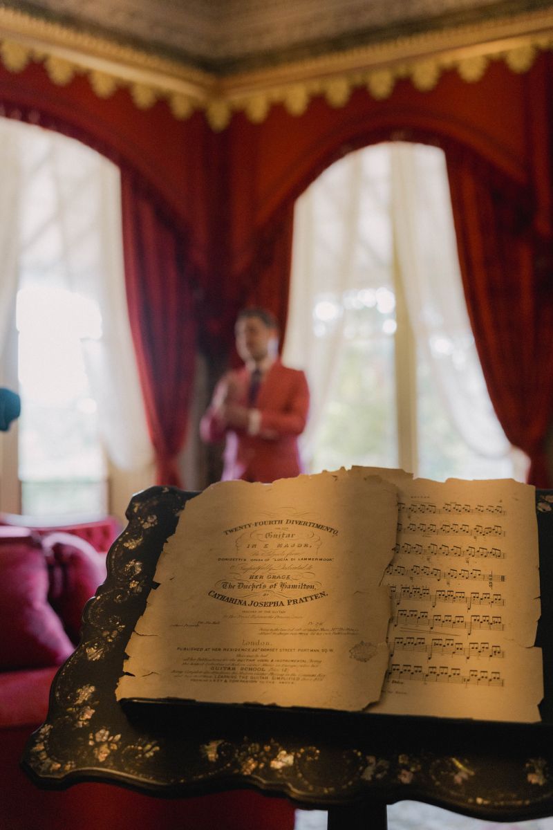 Historic hymnbook with ornate binding on display in the elegant interior of Vaucluse House—documentary wedding photographer Sydney capturing heritage wedding venue details and ceremony ambiance