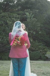 Bride in wedding dress and veil holding vibrant bouquet in the garden at Vaucluse House—documentary wedding photographer Sydney capturing intimate bridal portrait at heritage wedding venue