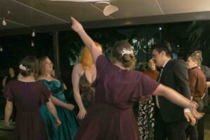 Guests dancing and celebrating at an evening wedding reception under a tent—Japanese candid wedding photographer capturing authentic celebration moments at Sydney weddings
